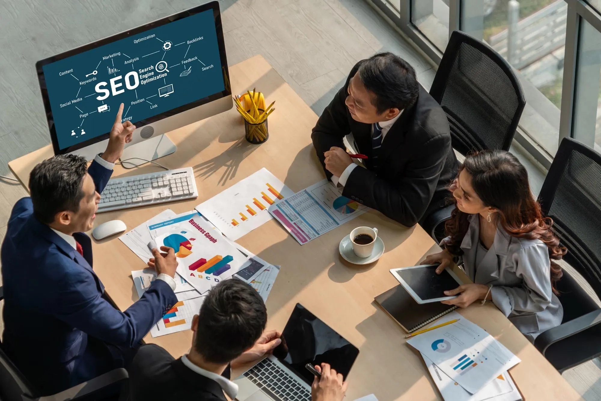 Professional digital marketing team discussing SEO strategy and business growth at DMXpert.